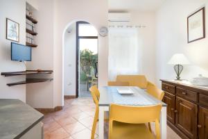 a kitchen and dining room with a table and chairs at Appartamento da Manzela 2 in Cala Gonone