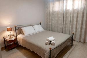 a bedroom with a bed with a teddy bear on it at Irinis Apartments Karfas, Chios in Chios +20 photos
