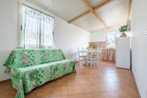 a living room with a couch and a table at Medusa Apartment in Taormina