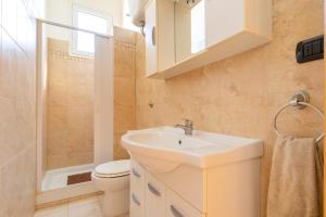 a bathroom with a sink and a toilet and a shower at Villa Ramirez in Leuca +21 photos