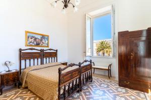 a bedroom with a bed and a window at Villa Ramirez in Leuca