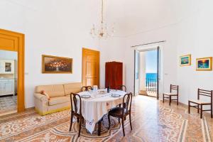 a living room with a table and a couch at Villa Ramirez in Leuca