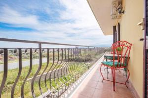 a balcony with two chairs and a view of the ocean at Medusa Apartment in Taormina