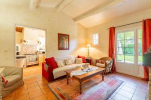 a living room with a couch and a table at La Rivière in Velleron