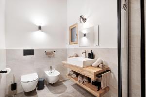 a bathroom with a white sink and a toilet at Herzleierhof Rodeneck in Rodengo +78 photos