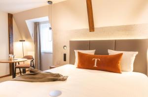 a hotel room with a bed and a table at Hôtel Maison Turenne in Colmar +71 photos