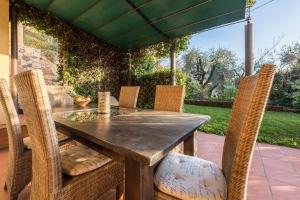 a wooden table and chairs on a patio at Ferienwohnung Gardasee Castion in Castion Veronese