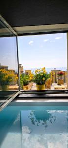 a view of a swimming pool from a window at Cinque Terre Homes by Bluchalet in Riomaggiore