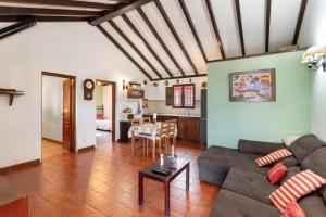a living room with a couch and a table at La Finca de Teror in Teror
