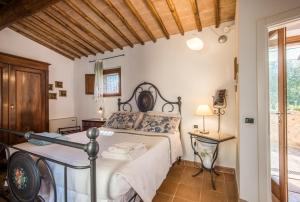 a bedroom with a bed and a table at La Farneta in Monteriggioni +18 photos