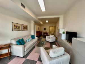 a living room with two couches and a flat screen tv at Bruseschi Appartament in Grado