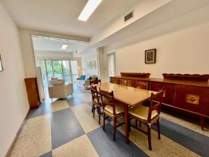 a living room with a wooden table and chairs at Bruseschi Appartament in Grado