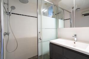 a bathroom with a shower and a sink at Maison 4 chambres fb112 in Le Barcarès +22 photos