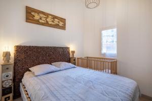 a bedroom with a bed with a blue comforter at Maison 4 chambres fb112 in Le Barcarès