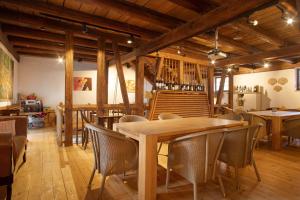 a dining room with wooden tables and chairs at Villa Puppenhaus in Immenstaad am Bodensee