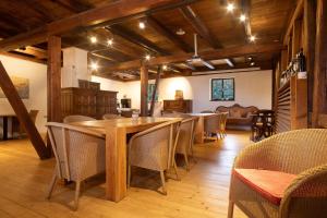 a dining room with a wooden table and chairs at Villa Puppenhaus in Immenstaad am Bodensee