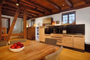 a kitchen with a table with a bowl of apples on it at Villa Puppenhaus in Immenstaad am Bodensee +127 photos