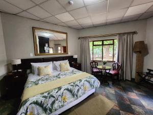 a bedroom with a bed and a mirror and a table at Goodnight Guest Lodge in Johannesburg +271 photos