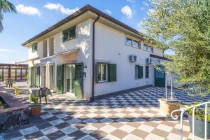 an exterior view of a house with a checkered floor at Casa Orchidea in Calatabiano
