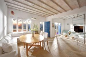 a living room with a table and a couch at Villa Crysta Mykonos in Mikonos