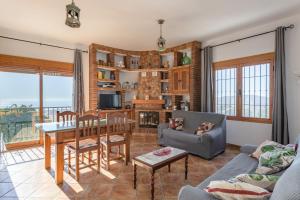 a living room with a table and a dining room at Casa rural Villena in Frigiliana