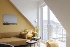 a living room with a couch and two tables at Strandhafer in Böhl