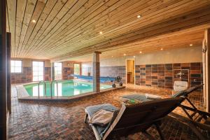 a large room with a swimming pool in a house at Chalet il fera beau demain in Villard-Reculas