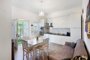 a living room and kitchen with a couch and a table at Bella veduta Luna in Agerola