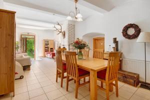 a kitchen and dining room with a wooden table and chairs at Schwarzbauernhof in Eschlkam