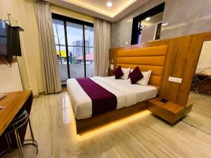a hotel room with a bed and a television at Hotel National - Grant Road in Mumbai +99 photos