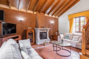 a living room with a couch and a fireplace at Casa Grau in Llanes