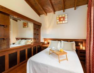 a bedroom with a bed with a table on it at Casa Grau in Llanes