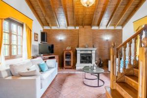 a living room with a white couch and a fireplace at Casa Grau in Llanes +21 photos