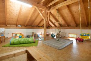 a large living room with a room with a swing at Schwarzbauernhof in Eschlkam