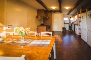 a kitchen with a table with a vase of flowers at Karu Holiday Home in Laiusevälja