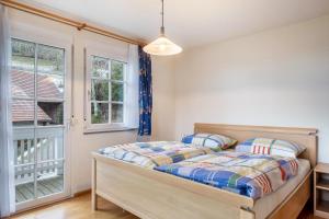 a bedroom with a bed and a window at Schornhof in Oberwolfach +39 photos