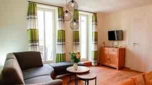 a living room with a couch and a table at Biobauer Heubach in Iphofen