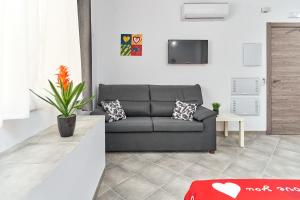 a living room with a couch and a tv at Nerja Boutique B2 Street level in Nerja