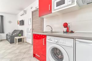 a kitchen with a washing machine in a room at Nerja Boutique B2 Street level in Nerja
