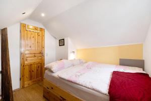 a bedroom with a bed and a wooden door at Picco 1 in Beuren