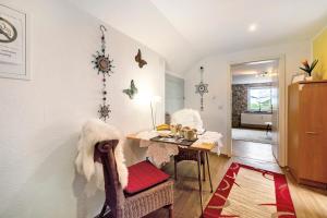 a living room with a table and a dining room at Picco 1 in Beuren