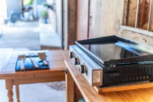 a toaster oven sitting on top of a wooden table at Maison - Le pic du midi in Roquefeuil
