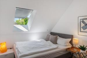 a bedroom with a bed and a small window at Villa Seebrise in Göhren-Lebbin