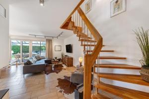 a living room with a staircase in a house at Villa Seebrise in Göhren-Lebbin