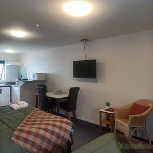 a hotel room with a bed and a table with chairs at #4 Glenorchy Alpine Suite in Glenorchy