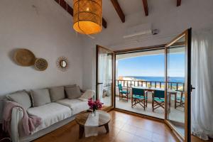 a living room with a couch and a view of the ocean at Apartamento Natalia in Menorca