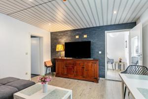 a living room with a flat screen tv on a wall at Kleines Haus in Bernau bei Berlin