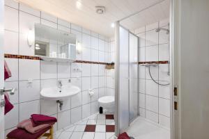 a bathroom with a toilet and a sink and a shower at Bauernhof Angelika Schulze Pellworm in Pellworm +16 photos