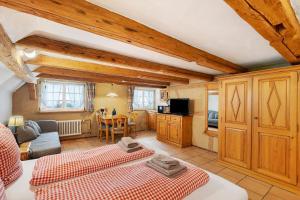 a living room with two beds and a kitchen at Holzwurm Apartments in Sasbachwalden