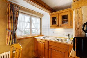 a kitchen with a sink and a window at Holzwurm Apartments in Sasbachwalden +223 photos